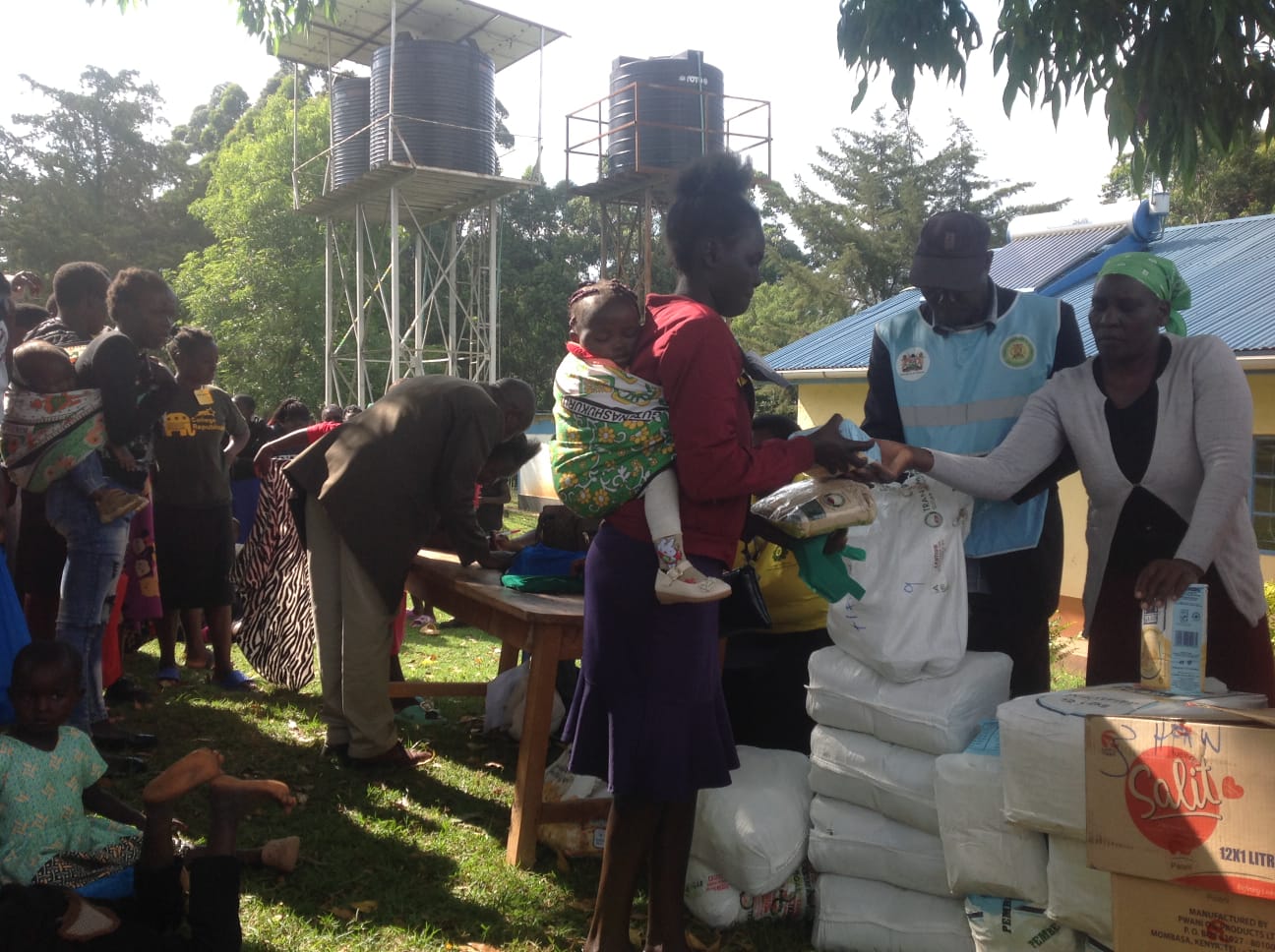 HFAW handing over food supplies to a teen mother